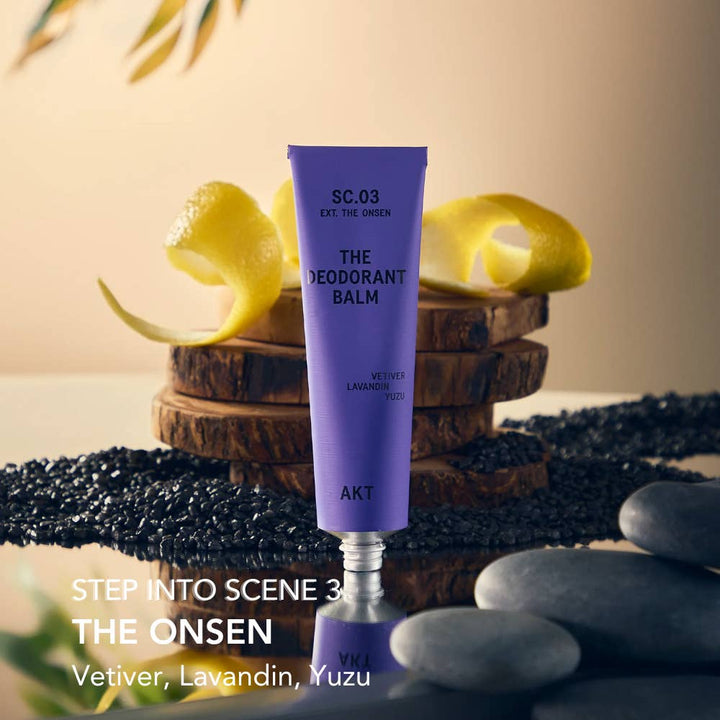 Purple deodorant balm with 'The Onsen' label on a natural setting with lemons and stones.  Plastic Free Zero waste